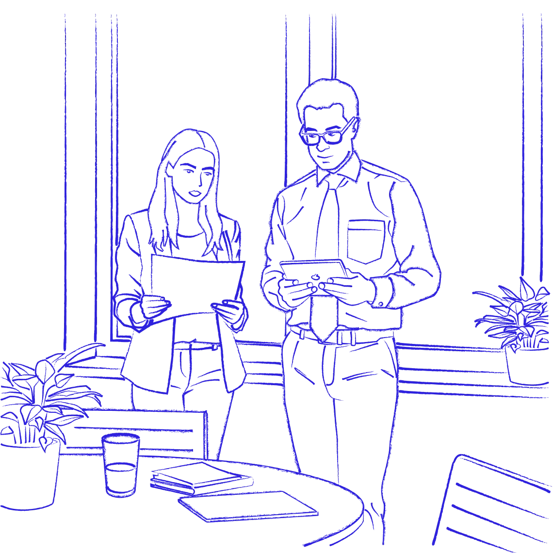 Business professionals reviewing documents by the window